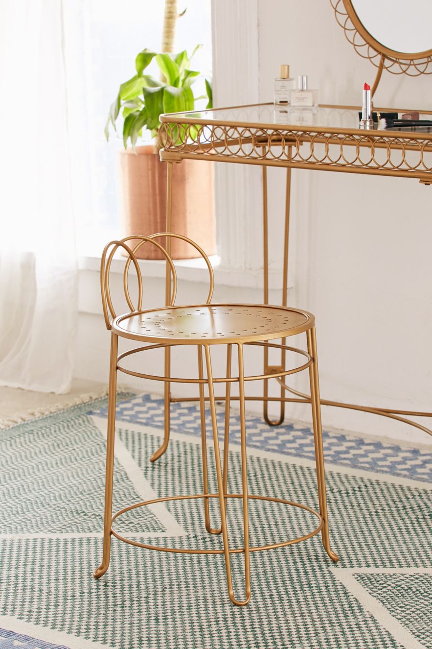 Iron vanity stool with a gold-toned finish