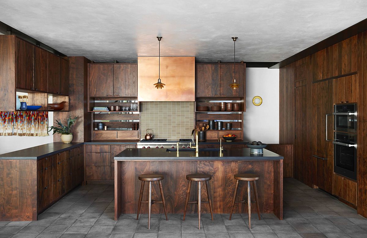 Kitchen with concrete ceiling and floor along with wram wooden shelves in Walnut