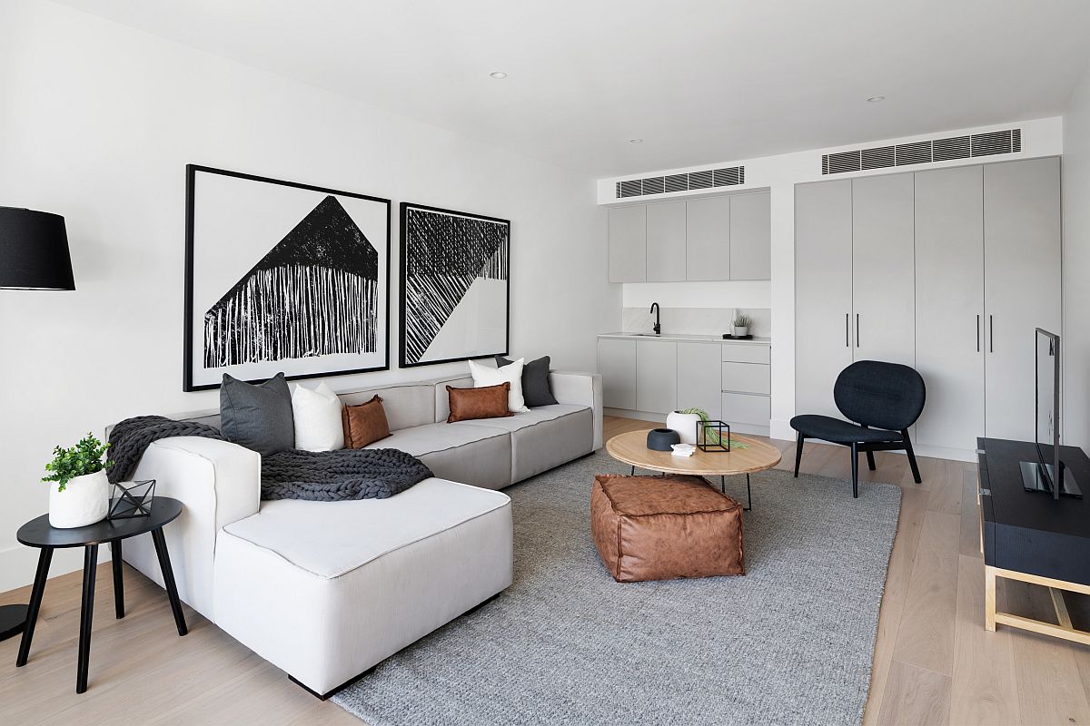 Large contemporary sectional in white sits perfectly in this beautiful and modest living room