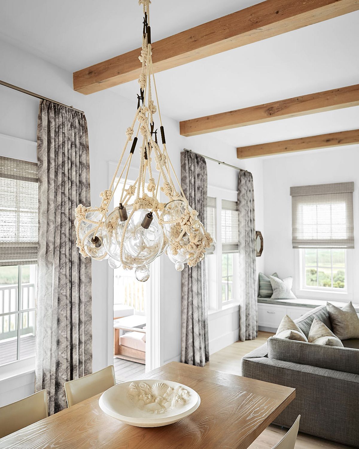 Lighting fixture in the dining room adds to the casual beach style of the home