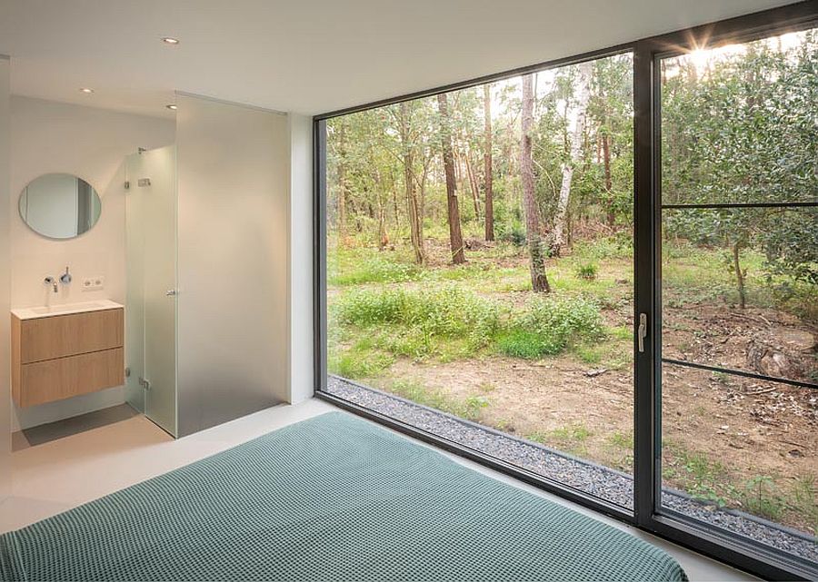 Main bedroom of the house with sliding glass doors that lead into the woods