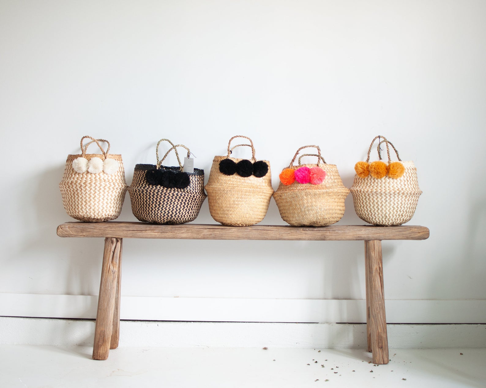 Mini woven baskets with pom poms