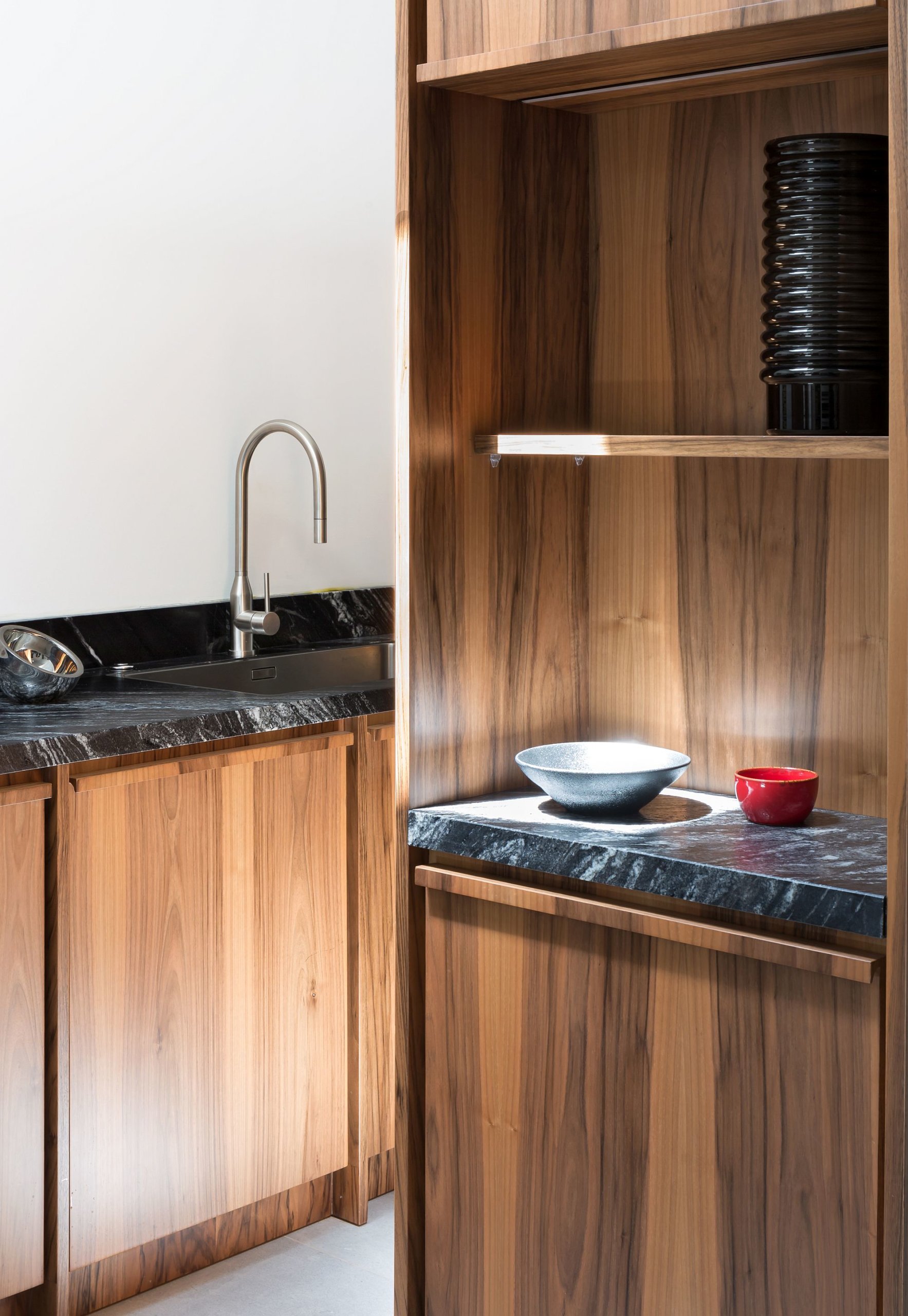 Natural black granite worktops in the kitchen coupled with wooden cabinets create a fabulous atmosphere