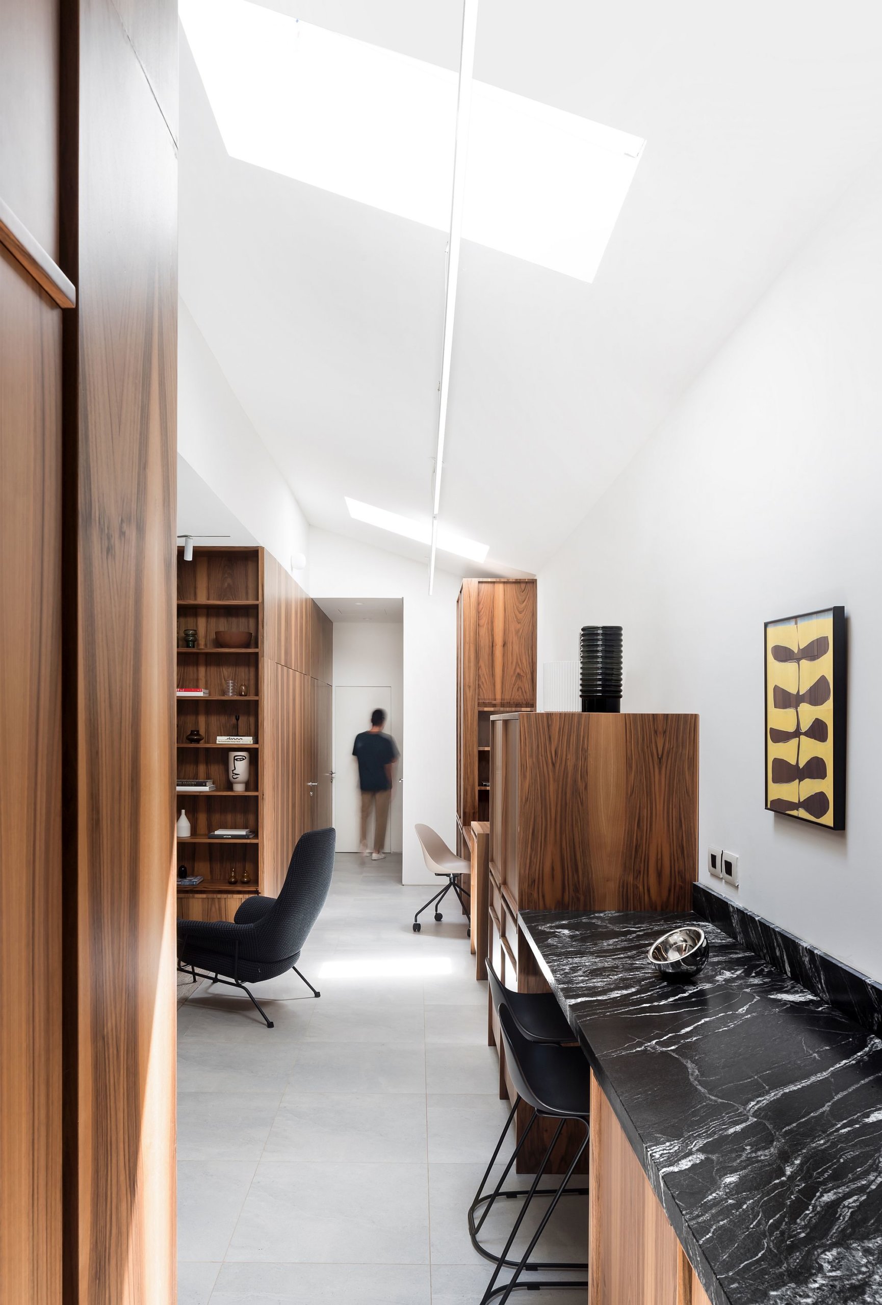 Natural black worksurface in the kitchen snd beyond adds dark charm to the interior