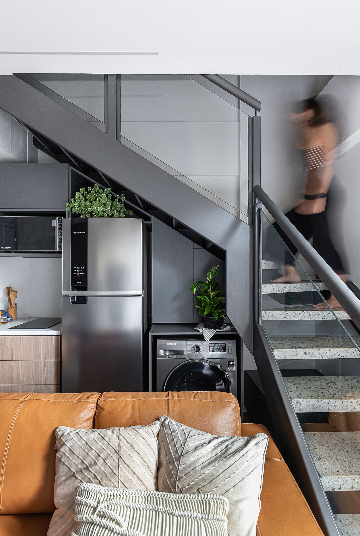 Old staircase of the house was remodeled and painted gray to allow it to fit in with the new style of the loft