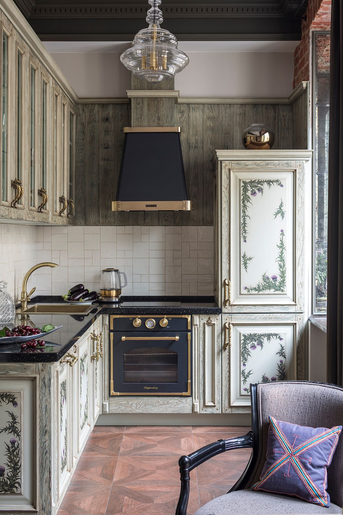 Ornate pattern for the cabinets coupled with copper trims for the hood and the appliances gives this kitchen a Victorian vibe