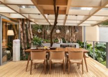 Picture-perfect-outdoor-dining-area-with-pendant-lights-and-a-lovely-wooden-table-that-easily-seats-eight-people-58863-217x155