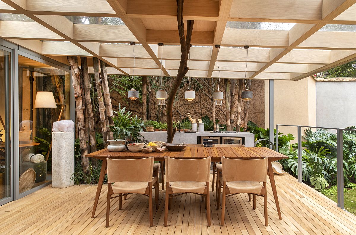 Picture-perfect-outdoor-dining-area-with-pendant-lights-and-a-lovely-wooden-table-that-easily-seats-eight-people-58863