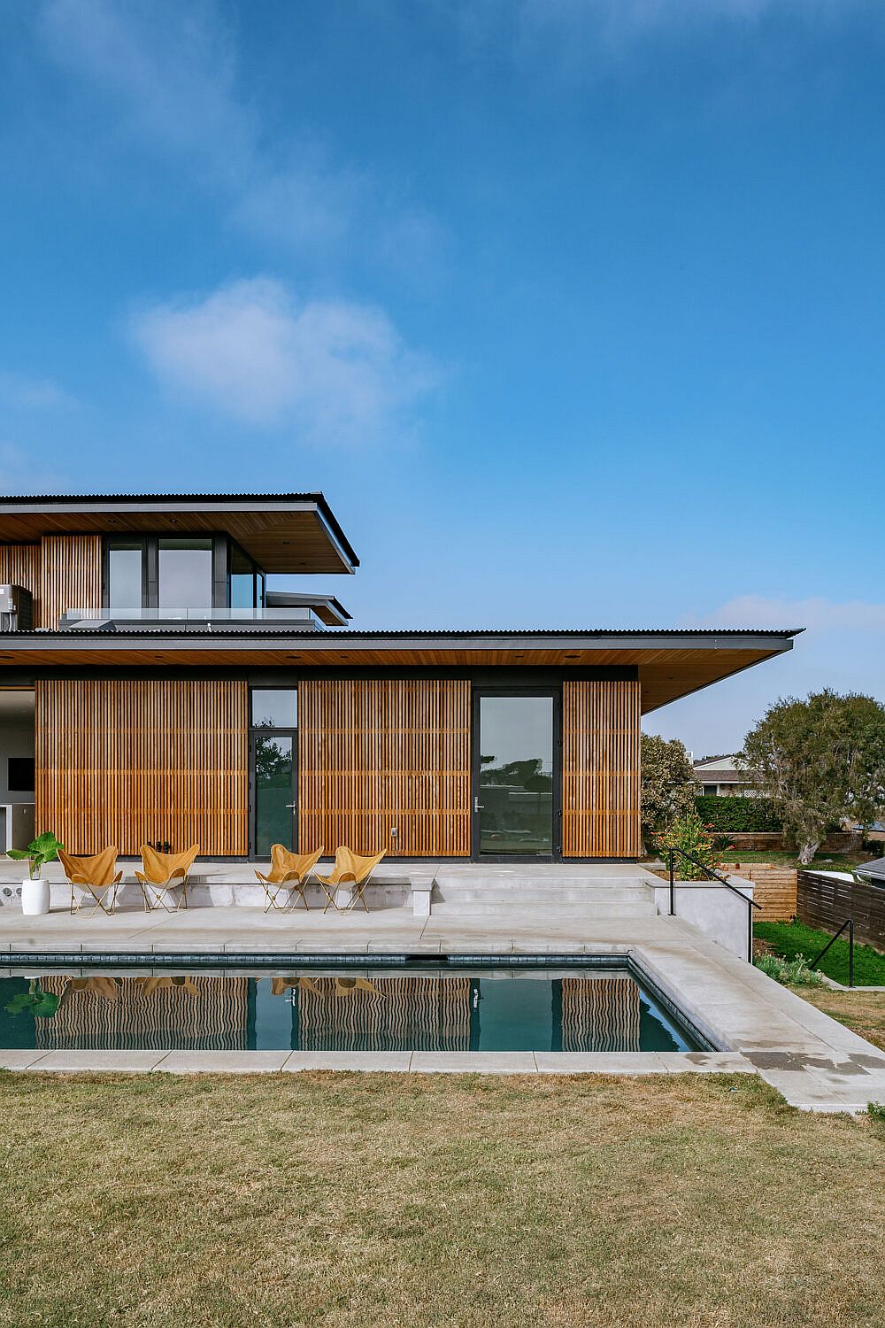 Pool and deck outside the house is connected with the interior using sliding glass doors