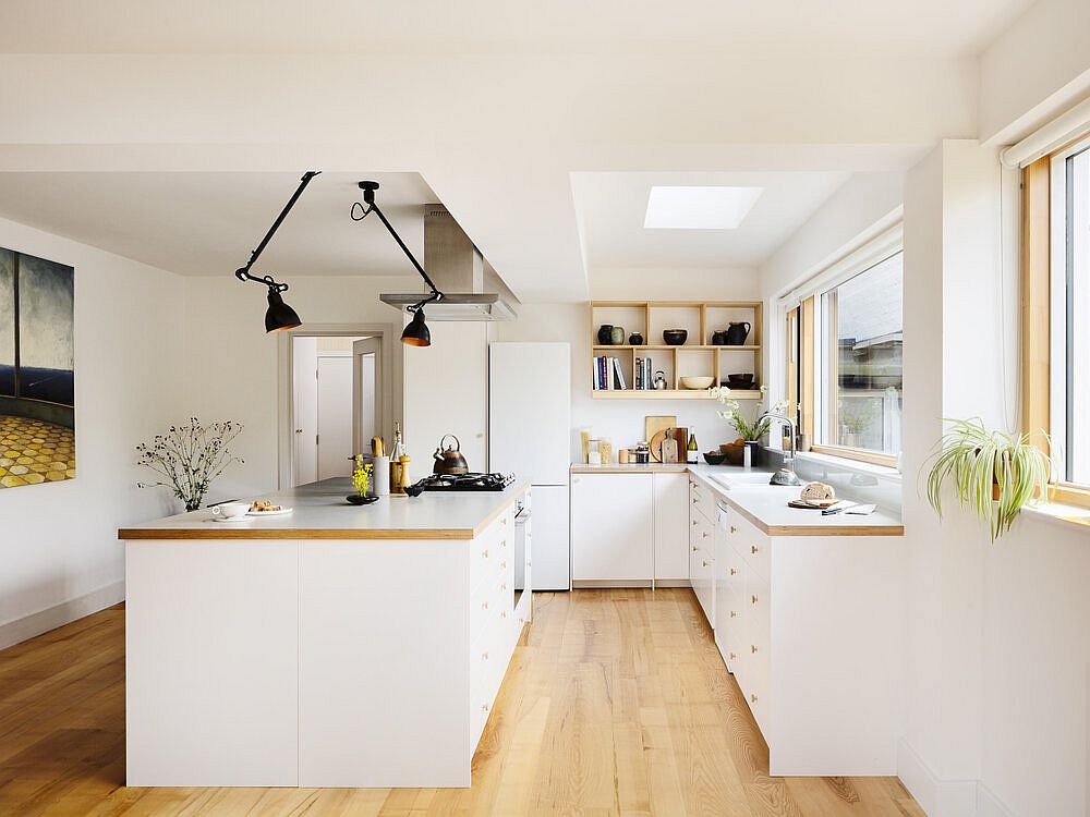 Skylight-and-sconce-lights-illuminate-the-white-and-wood-kichen-on-the-lower-level-elegantly-11065