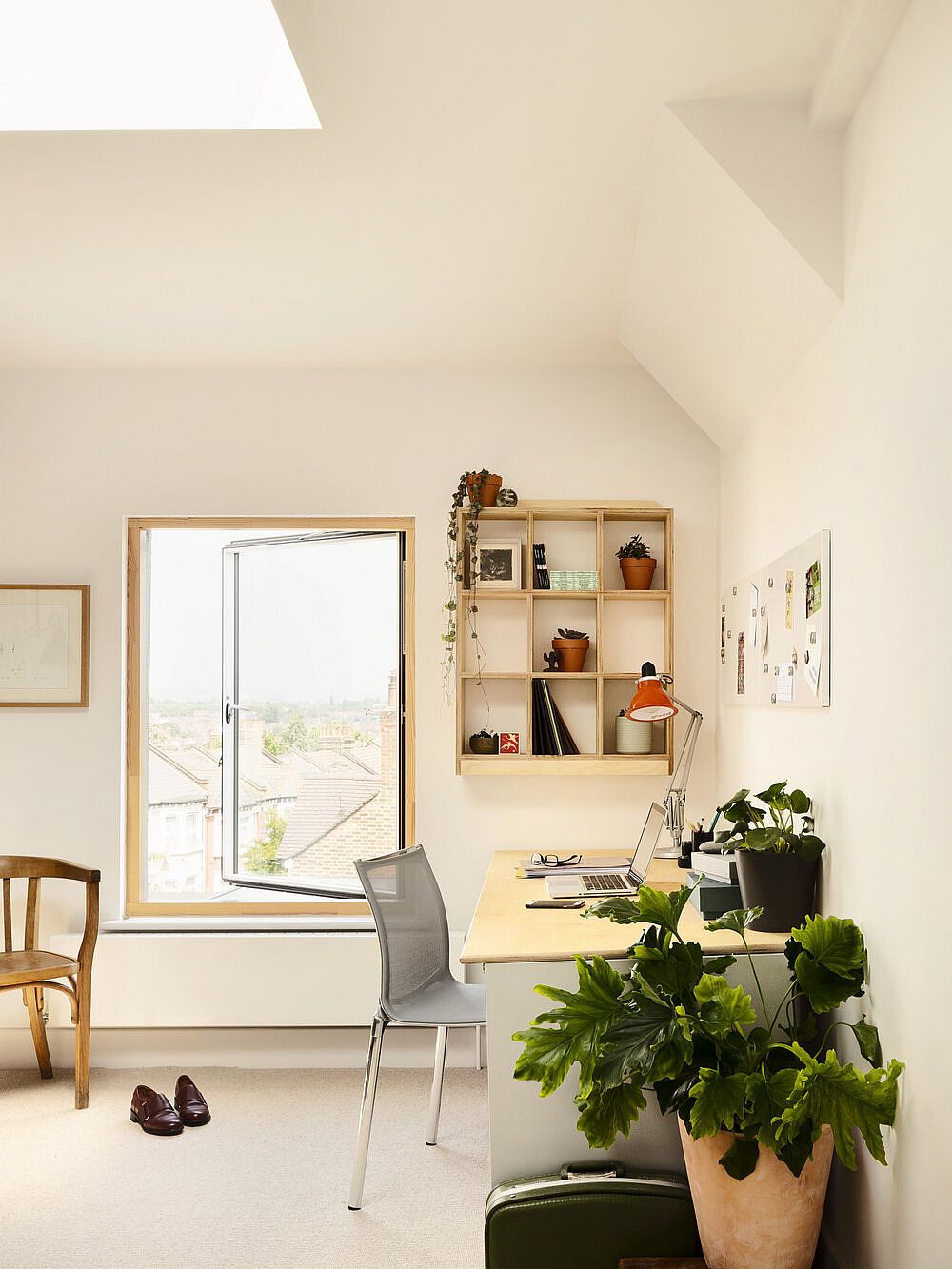 Skylight, windows and sconce lights illuminate the upper level home office