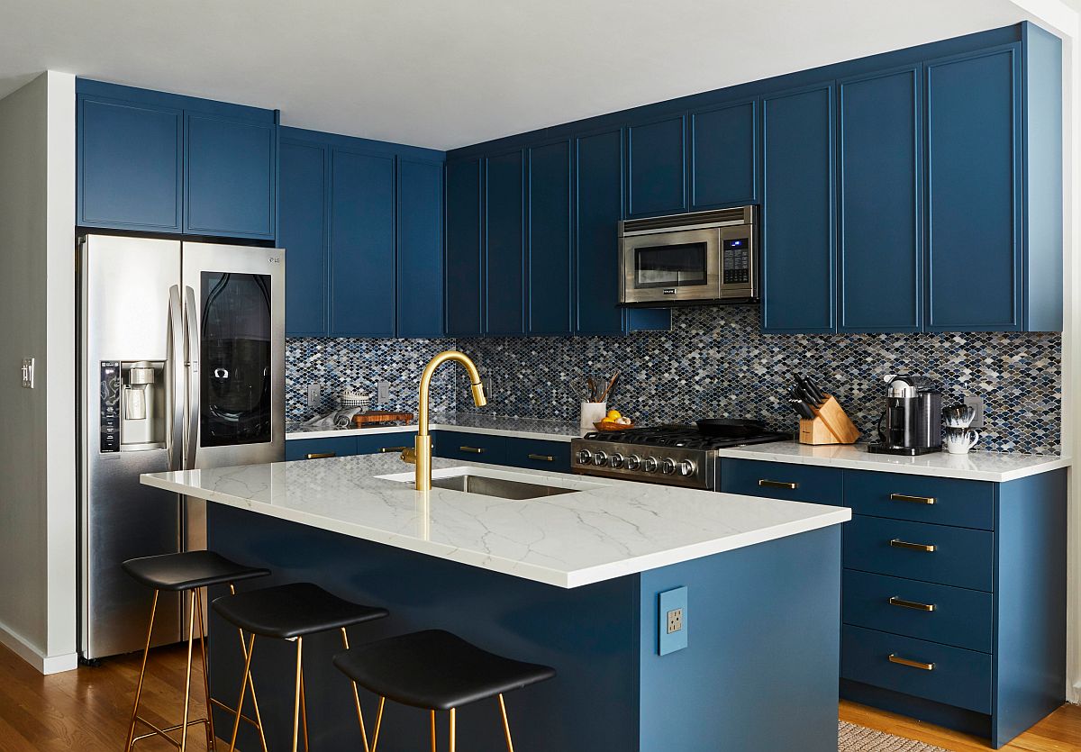 Small and stylish contemporary kitchen with dark blue cabinets and kitchen island alongw ith white countertops