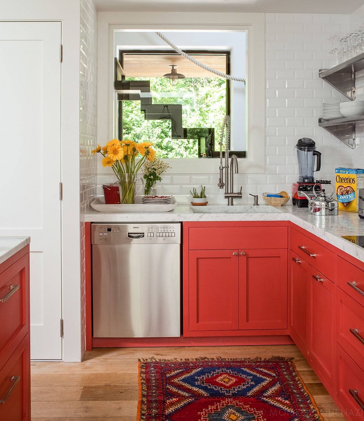 Small beach style kitchen with bright orangy-red cabinets and white backsplash