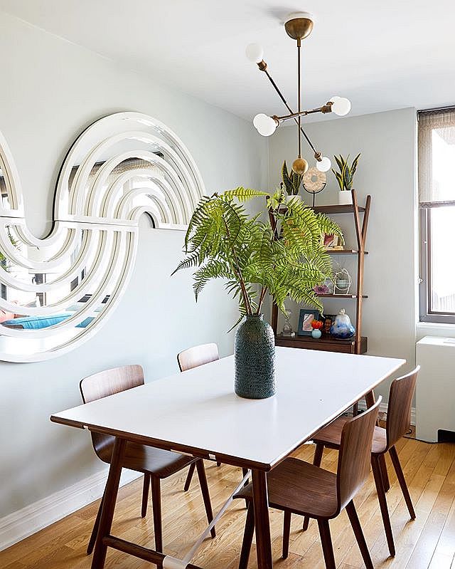 Small dining area of the Upper East Side Condo with wooden shelf in the corner