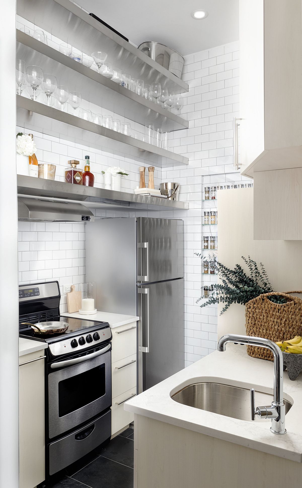 Stainless steel and white shape a fabulous and understated kitchen inside an apartment in Greenwich Village