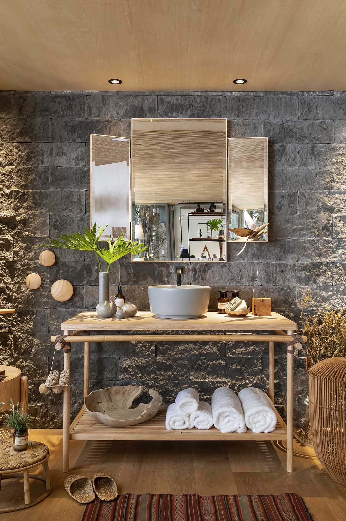 Stone walls fashion a unique backdrop in this smart bathroom