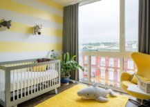 Striped-accent-wall-in-yellow-and-white-along-with-yellow-rug-and-chair-in-the-smart-modern-nursery-78865-217x155