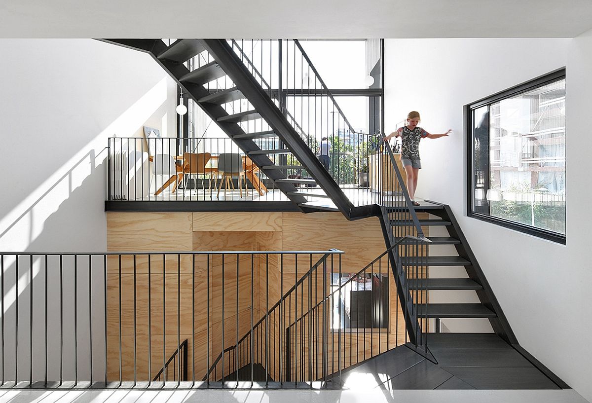 Stunning series of stairways connecting different levels of the house also create the central atrium
