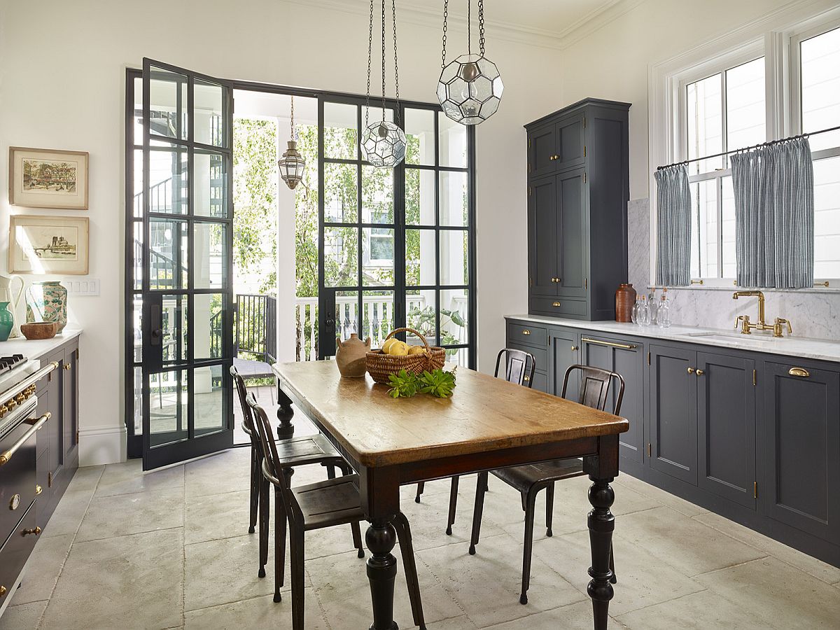 Table in wood at the heart of the kitchen serves both as dining space and prep zone