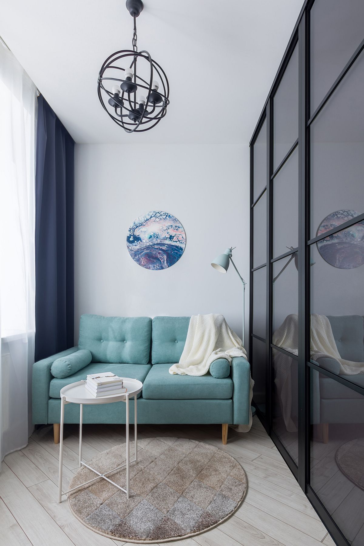 Tiny light blue sofa for an ultra-small living area inside small studio apartment