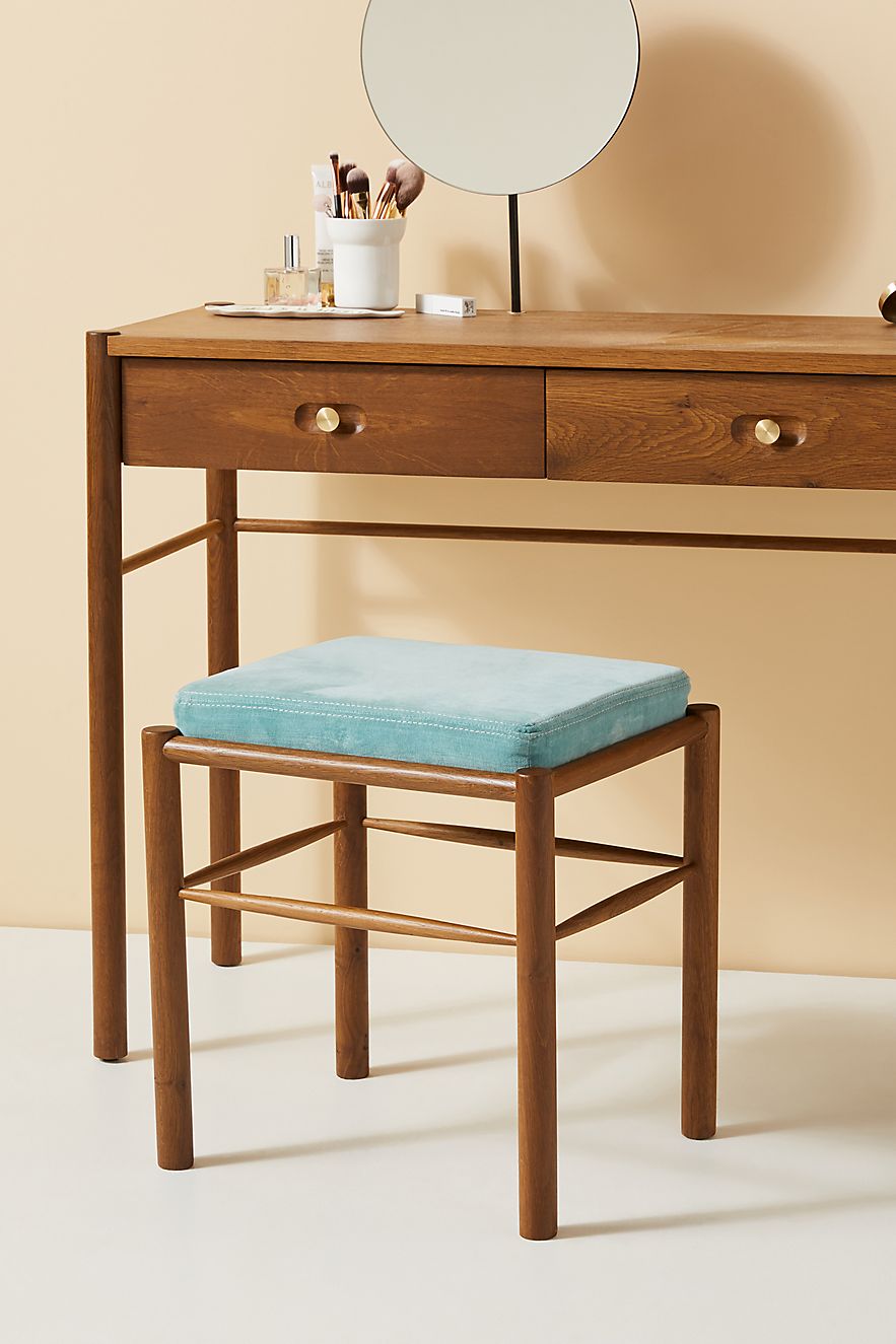 Wood vanity stool with a blue cushion