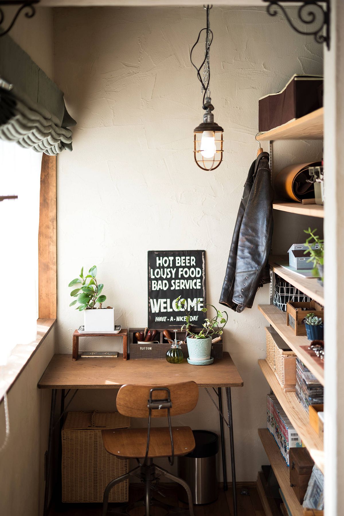 Wooden shelves and desk in the tiny eclectic home office offer smart functionality