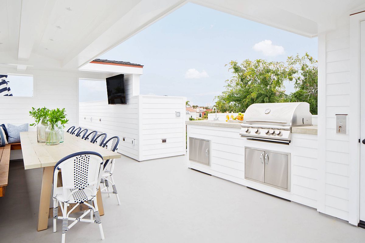 Awesome rooftop outdoor kitchen with a cheerful beach style and a covered dining space next to it