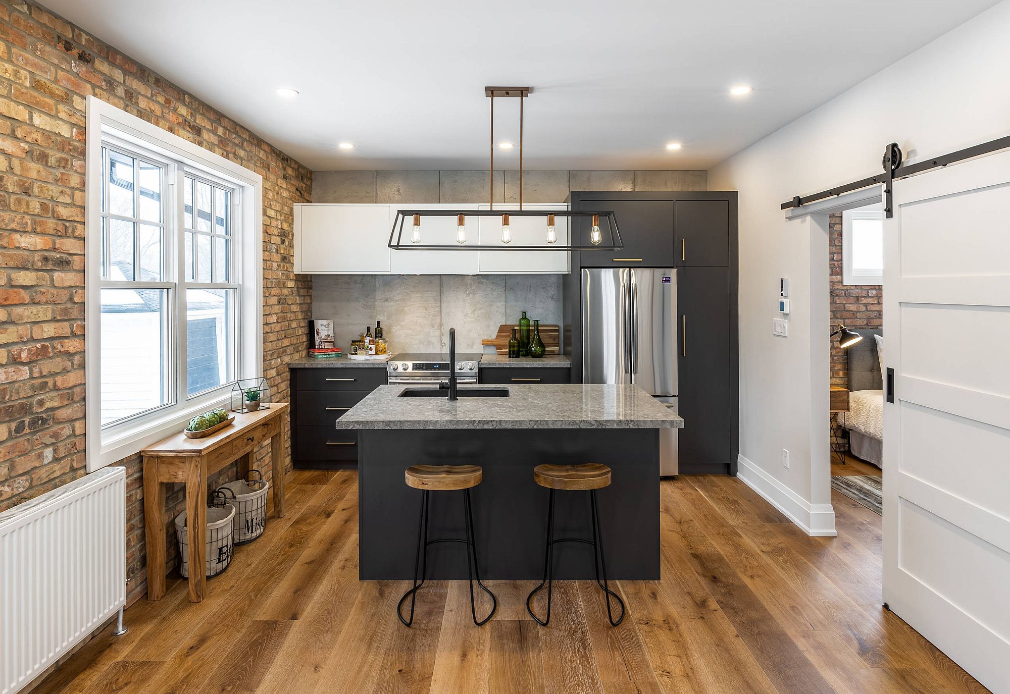 Balanced use of both modern and industrial styles in the modest kitchen with exposed brick wall