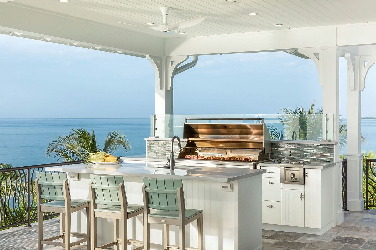 Beach style outdoor kitchen with a view of the ocean in the distance