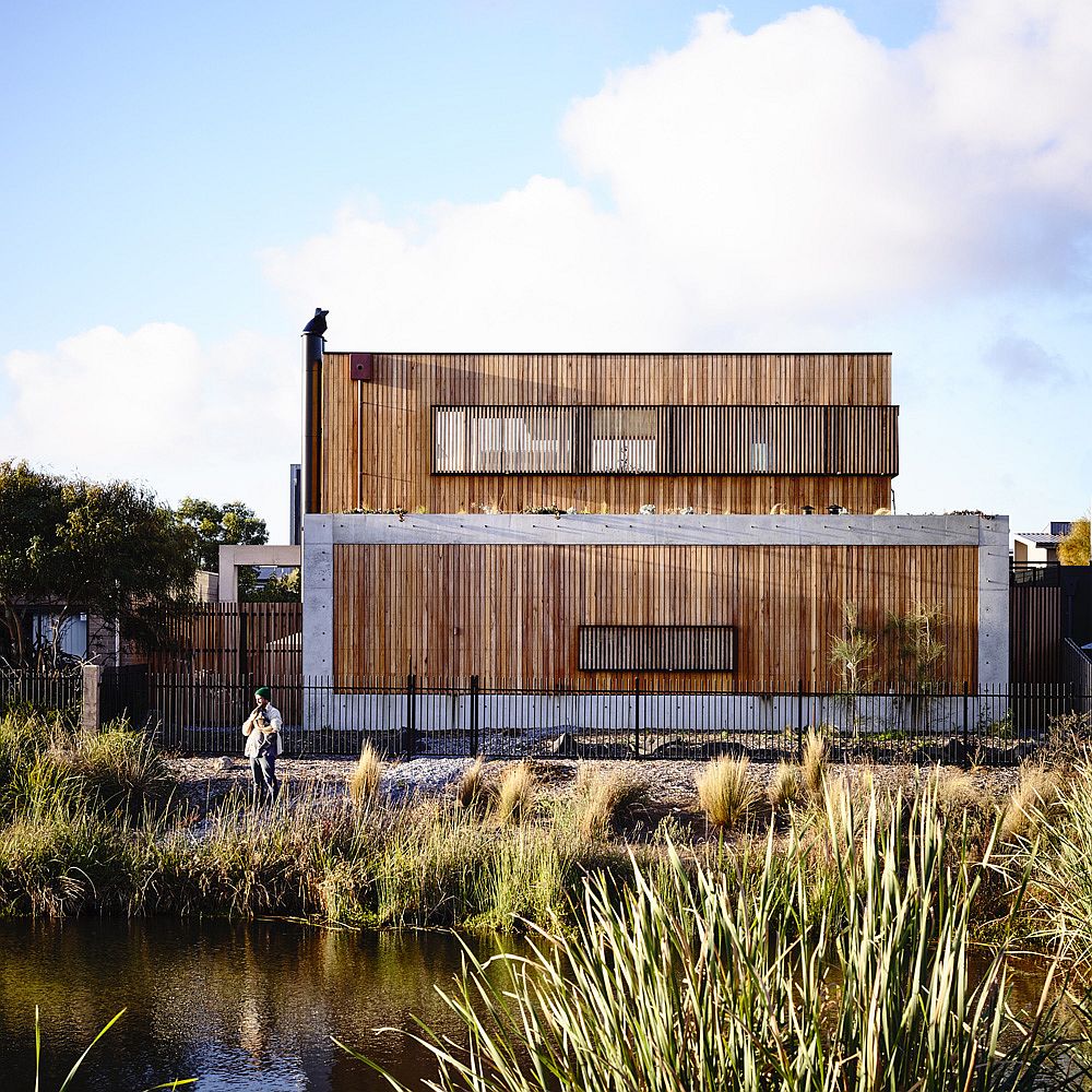 Beautiful home in concrete and wood opens up towards the wetlands and the gold course outside