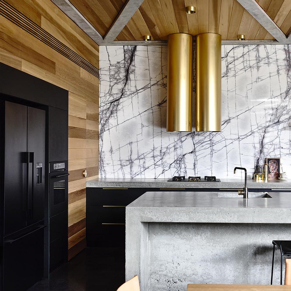 Bold metallic hoods along with marble backsplash in the kitchen shape a lovely focal point