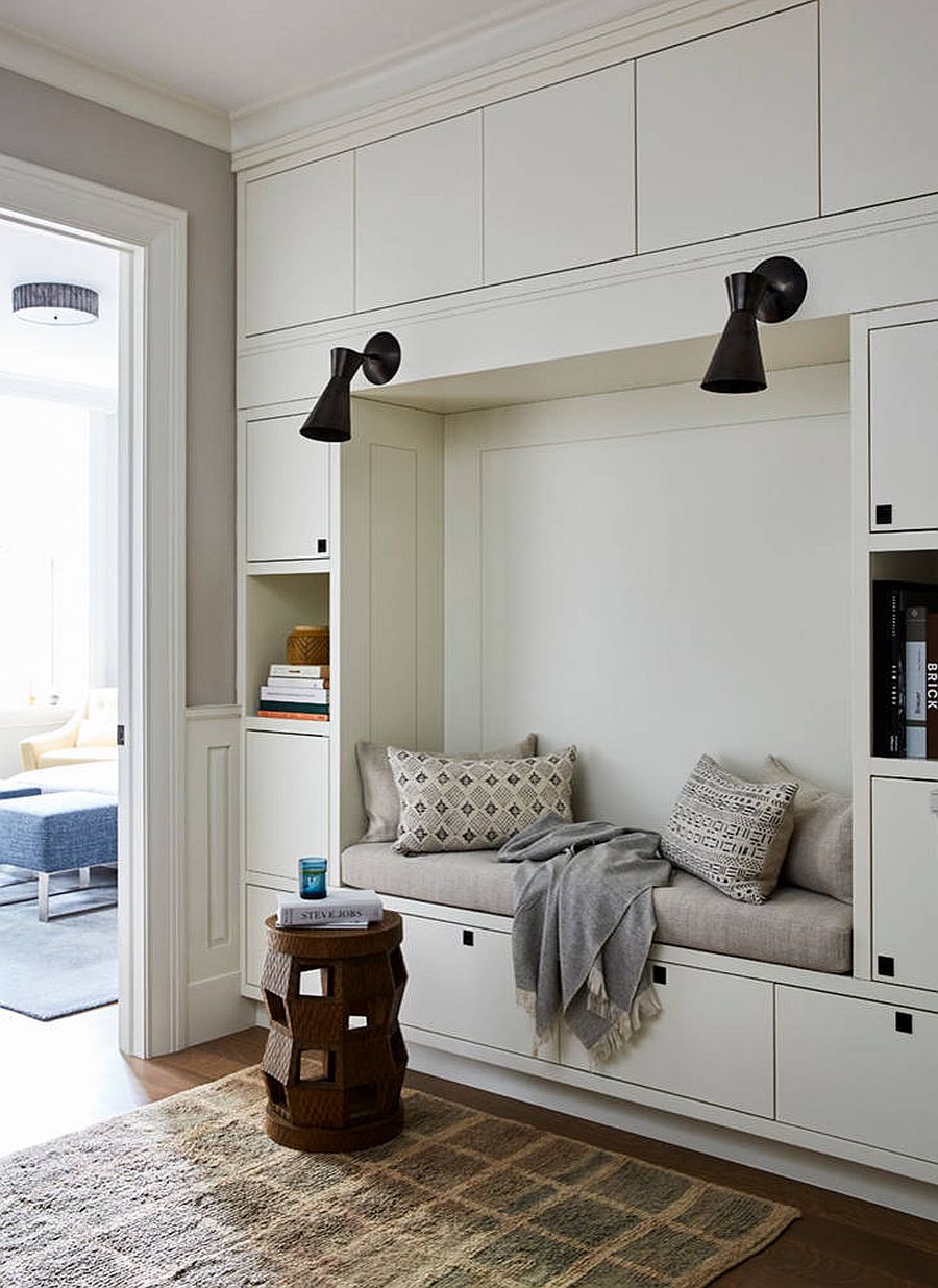 Collection of closed cabinet and open shelves creates space for storage and books in this bedroom