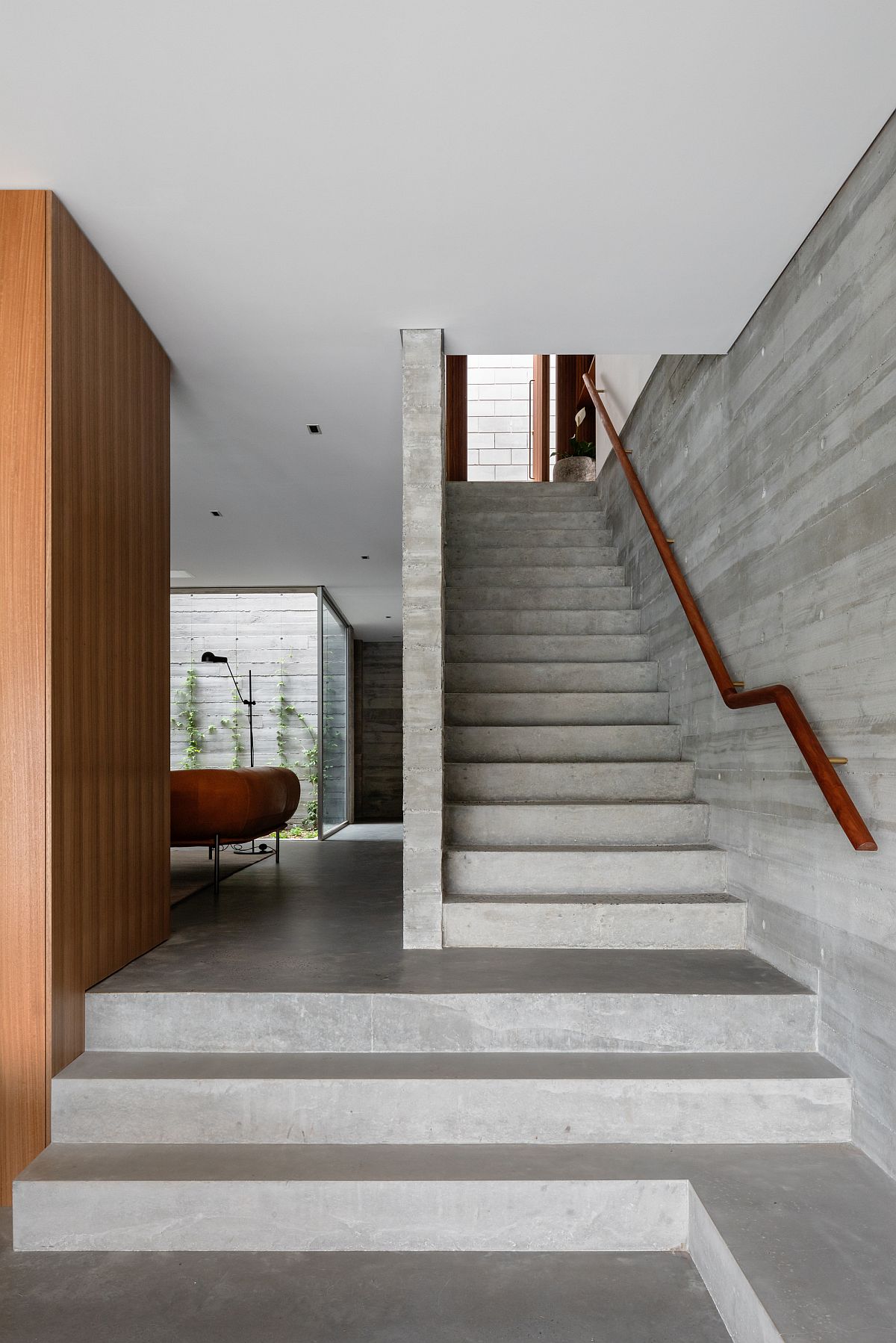 Concrete walls give the interior a minimal gray backdrop
