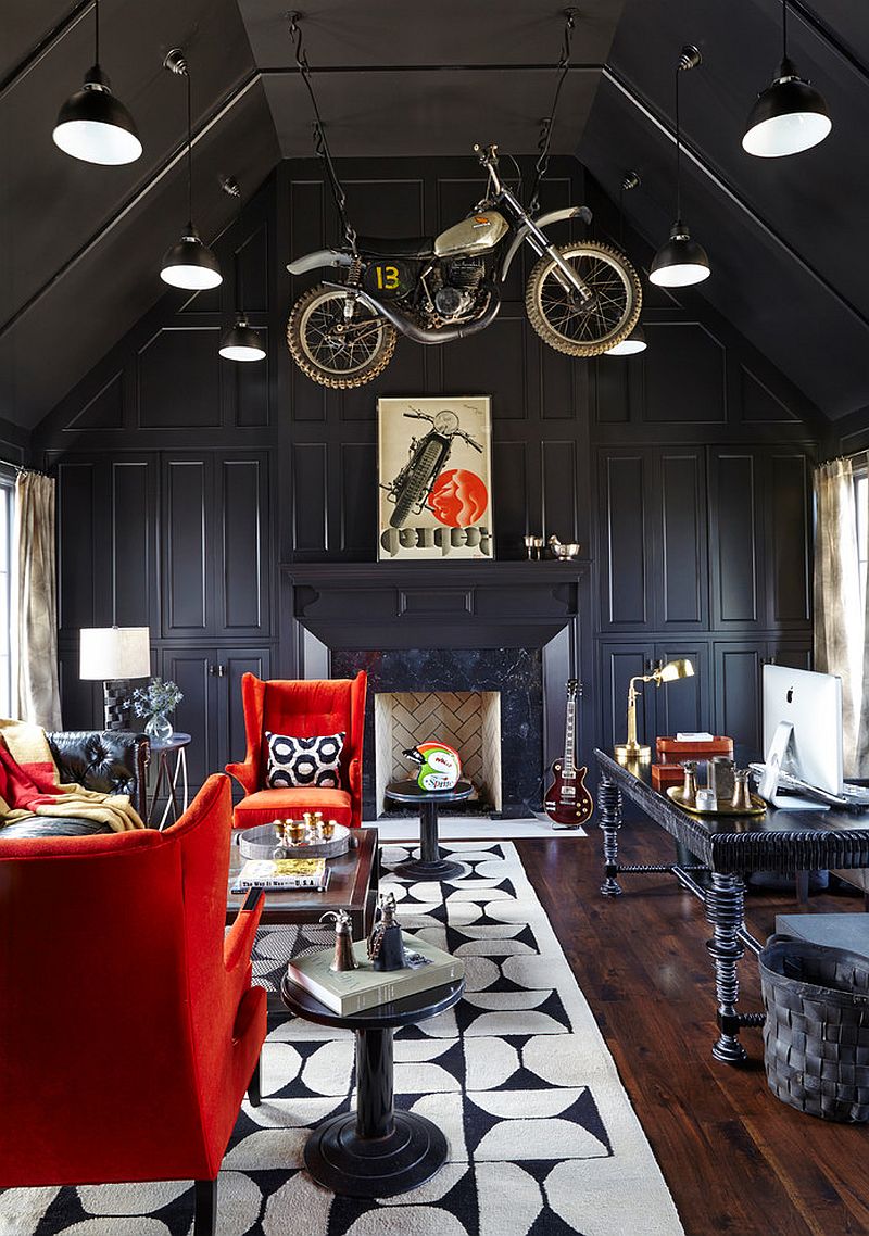 Contemporary home office in black with bold red accents brought in by comfortable chairs