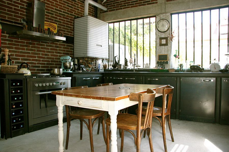 Corner space comes in mighty handy in the small industrial kitchen with exposed brick wall backdrop