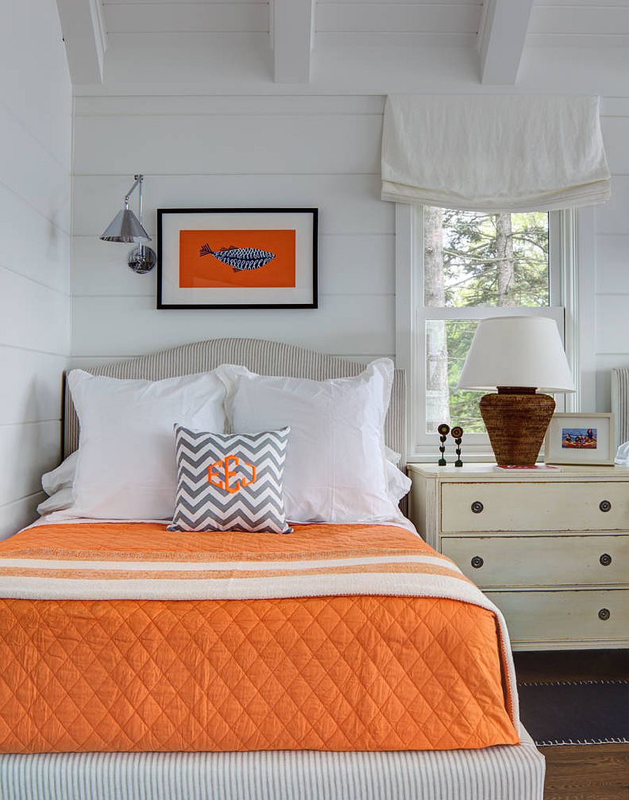 Creative use of orange accents in the modern coastal bedroom with a white backdrop