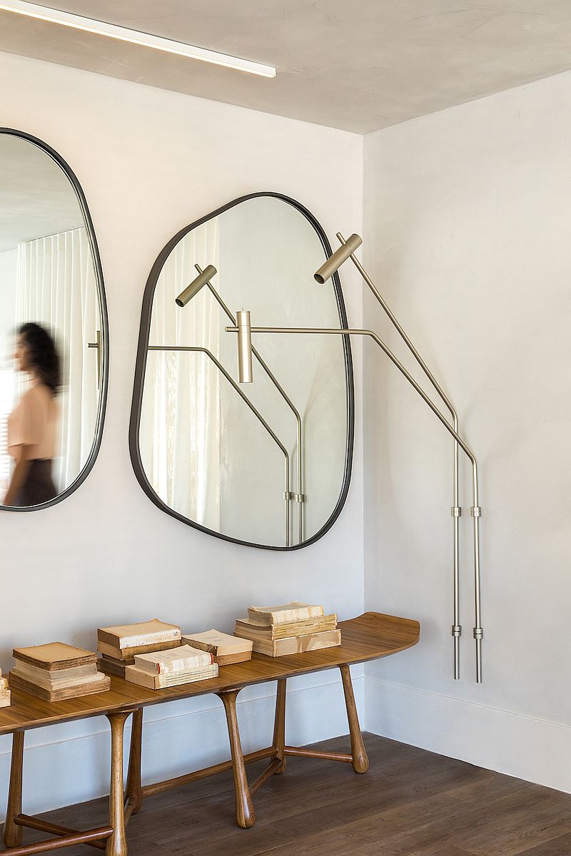 Creative use of slim console table and mirrors to decorate the hallway