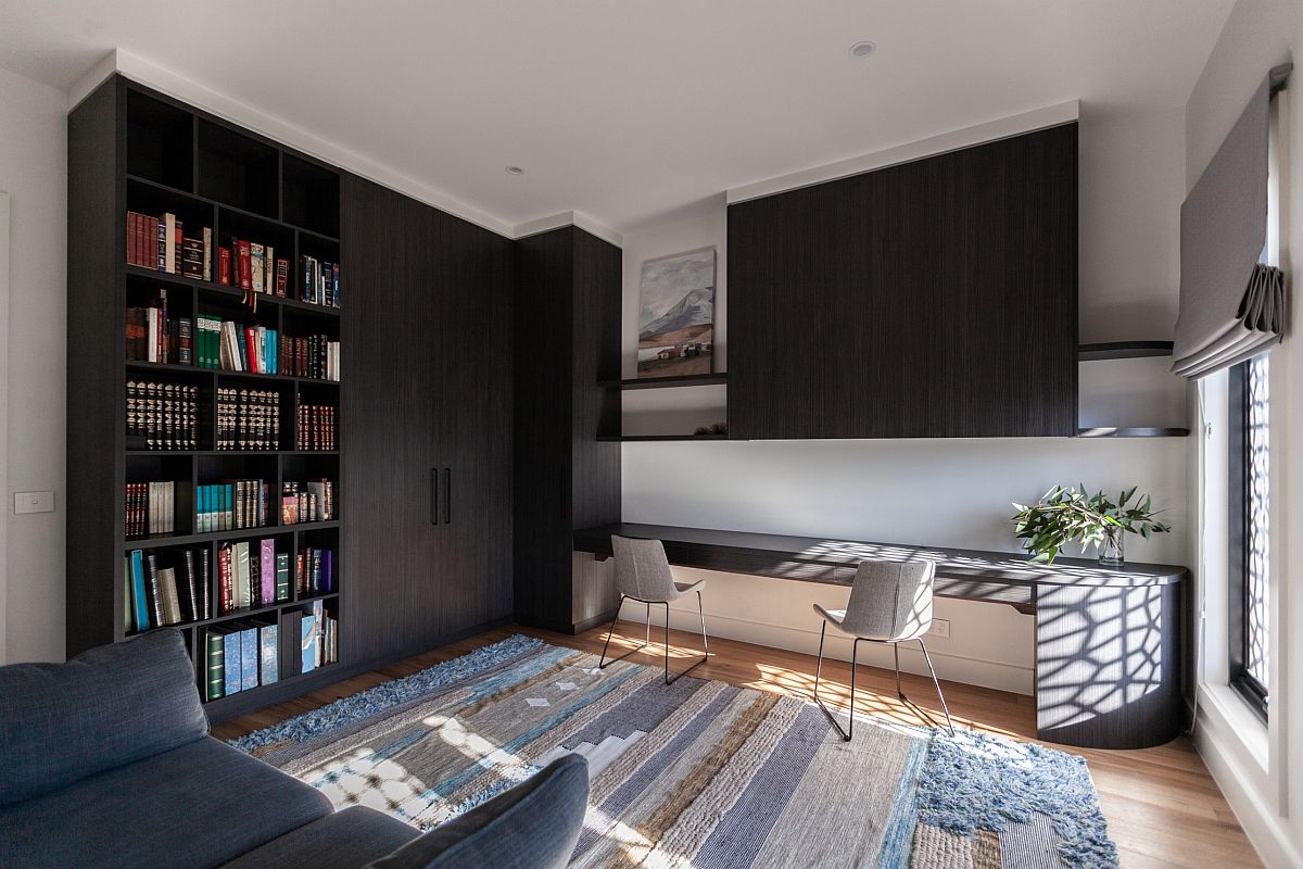 Dark wooden cabinets add black to this lovely and light-filled home office