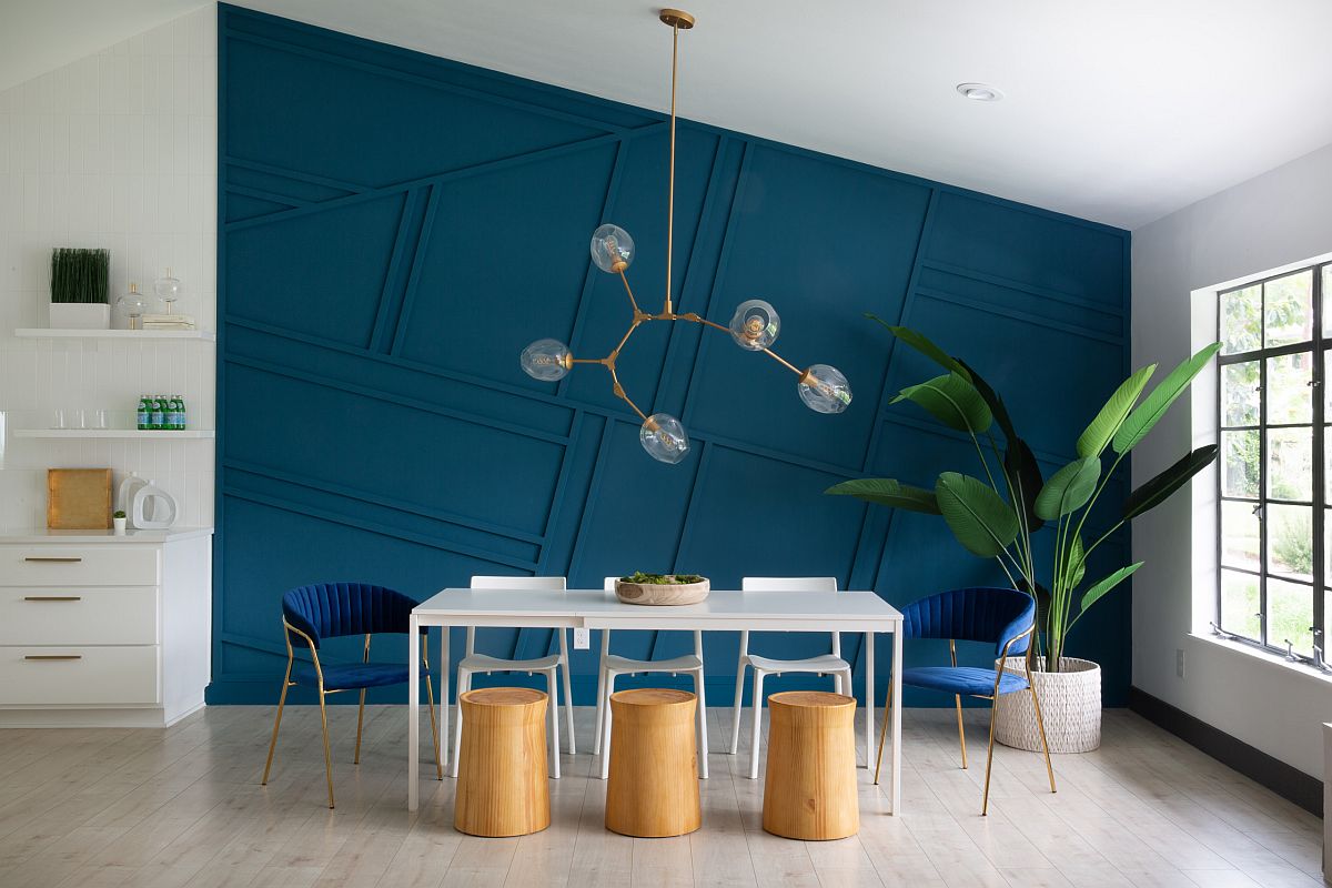 Dashing dark blue backdrop in the dining room also adds geometric style to the minimal space