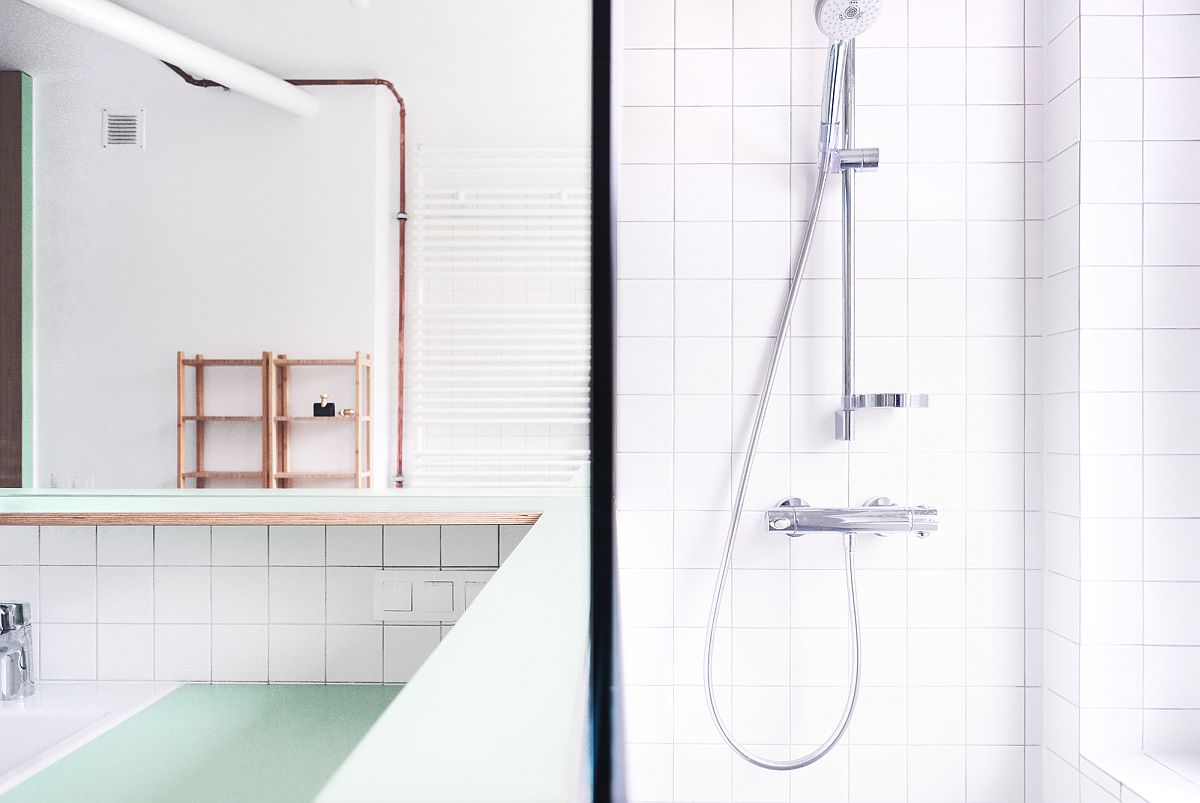 Delightful, light-filled apartment in white with exposed copper pipes that add metallic glint