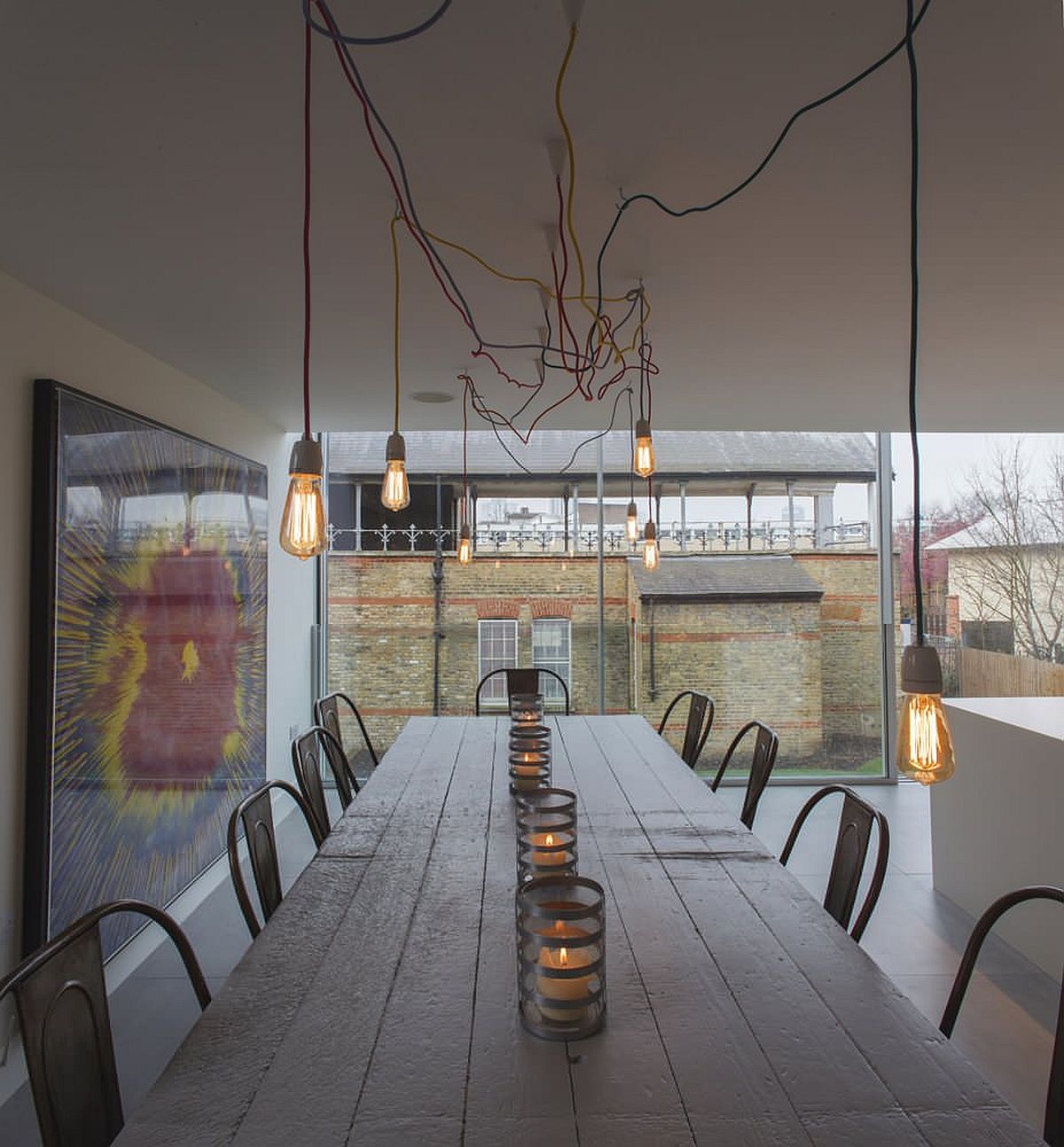 Edison bulb lighting adds industrial touches to this modern minimal dining space