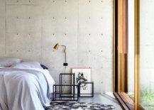 Exposed-concrete-walls-create-a-modern-minimal-backdrop-in-the-bedroom-with-sliding-glass-doors-89734-217x155
