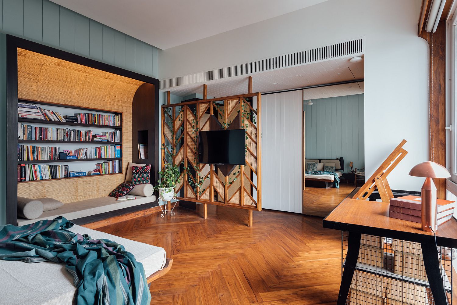 Exquisite bedroom with chevron pattern wooden flooring, fabulous reading nook with lovely bookshelf