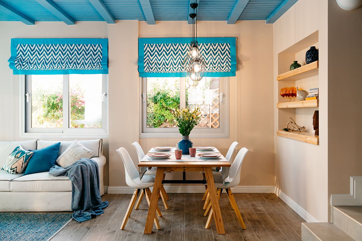 Eye-catching blue ceiling steals the show in this modest modern Mediterranean dining space