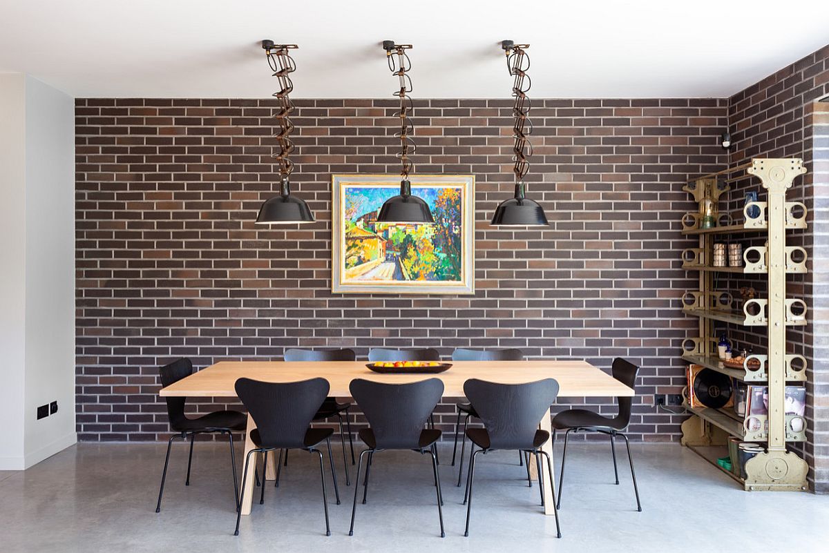 Faux brick walls, mid-century modern chairs and a polished deisgn bring the 50's back in this dining room!