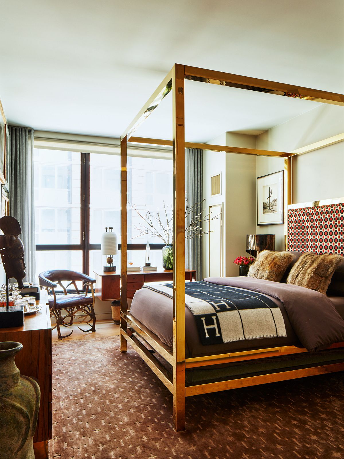 Four-poster bed with a golden metallic frame makes a statement inside this modern eclectic bedroom