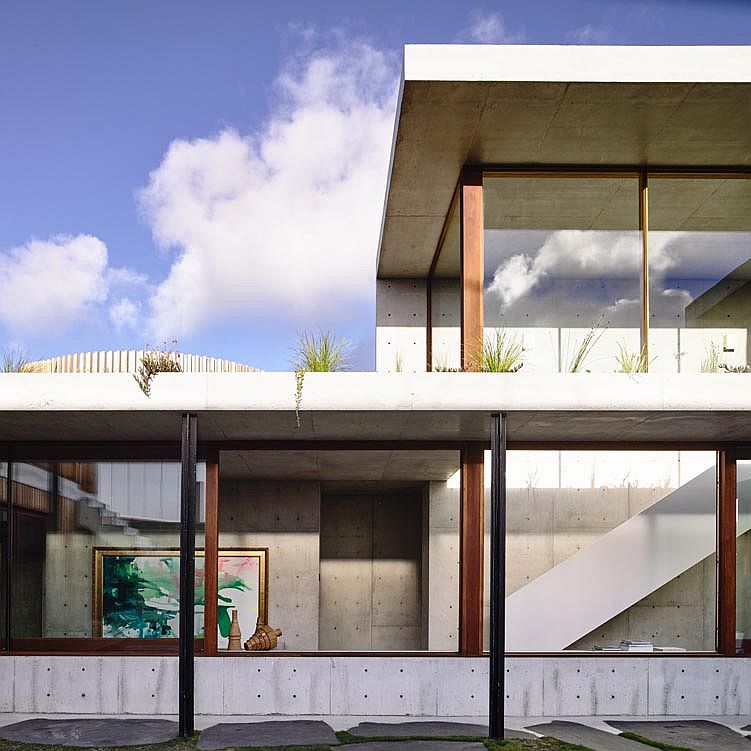 Glass walls connect the interior of the house and the hallways with the exterior outside