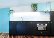 Kitchen-with-dark-cabinets-and-splashes-of-blue-is-perfect-for-the-modest-attic-flat-and-studio-48937-217x155