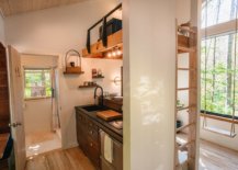 Kitchen-with-loft-level-reding-space-abve-inside-the-small-wooden-cabin-87361-217x155
