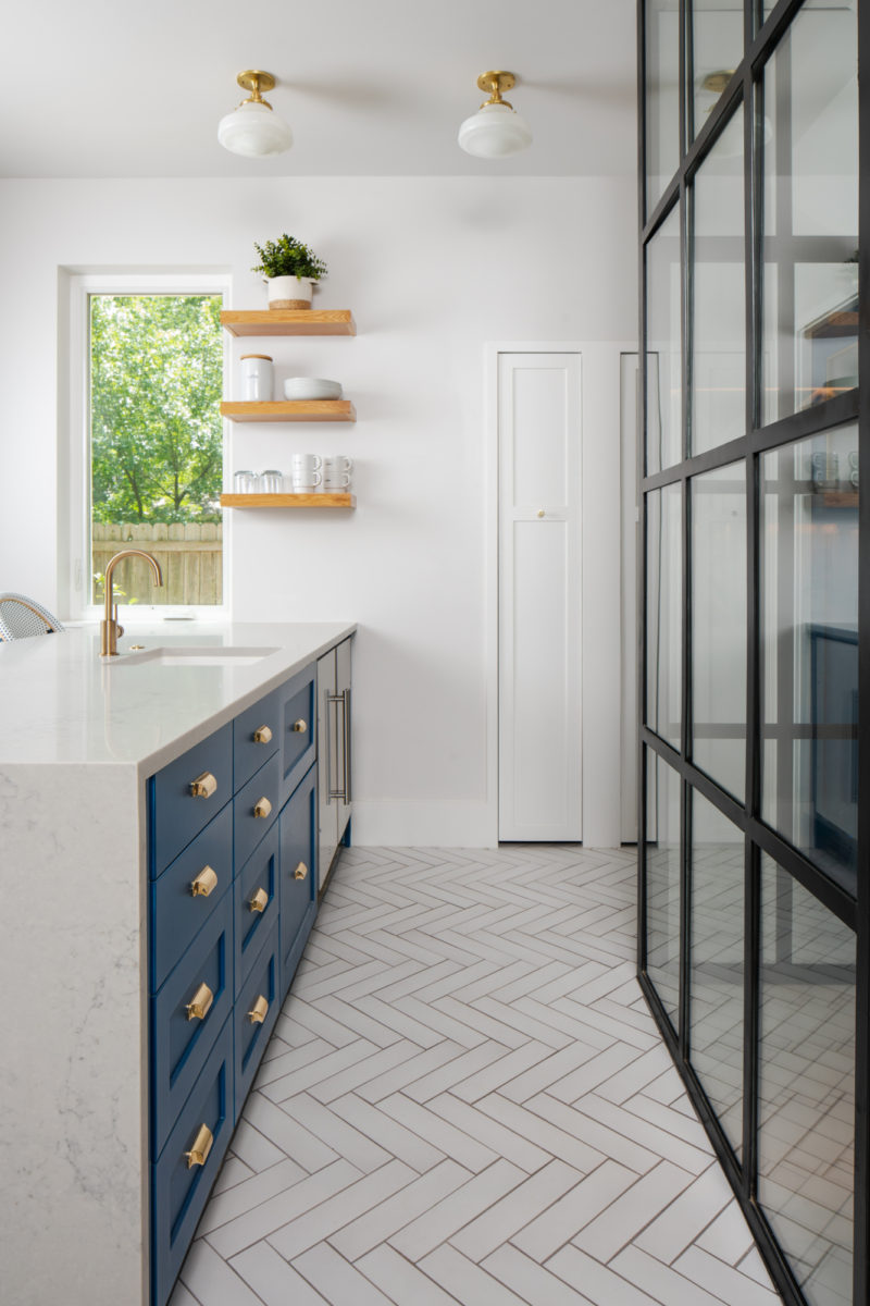 Kitchen with white herringbone floor tiles